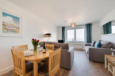 a living room with a table and a couch at 1 Bed in St Ives oc-cwn014 in St Ives