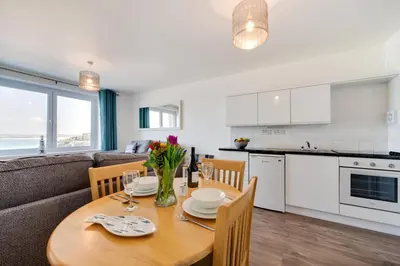 a kitchen and dining room with a table and a couch at 1 Bed in St Ives oc-cwn014 in St Ives