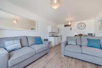 a living room with two couches and a kitchen at 1 Bed in St Ives oc-cwn014 in St Ives