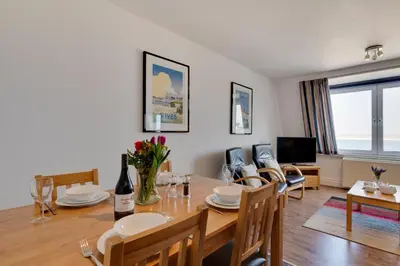 a dining room and living room with a table and chairs at 1 Bed in St Ives oc-cwn054 in St Ives