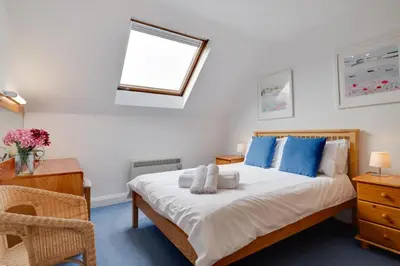 a bedroom with a bed with blue pillows and a window at 1 Bed in St Ives oc-cwn054 in St Ives