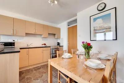 a kitchen with a wooden table and a dining room at 1 Bed in St Ives oc-cwn054 in St Ives