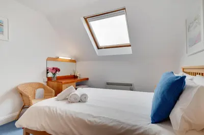 a bedroom with a white bed with towels on it at 1 Bed in St Ives oc-cwn054 in St Ives