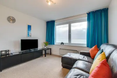 a living room with a couch and a flat screen tv at 1 Bed in St Ives oc-cwn31 in St Ives