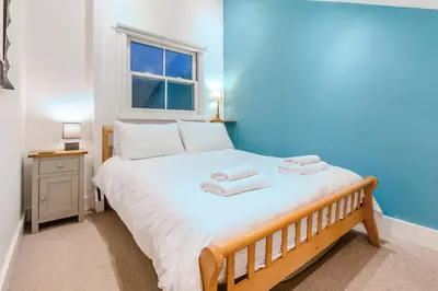 a bedroom with a large bed with two towels on it at 1 Bed in St Ives oc-decke in St Ives