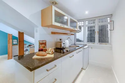a kitchen with white cabinets and a counter top at 1 Bed in St Ives oc-decke in St Ives