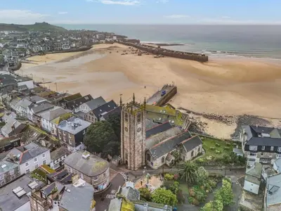 an aerial view of a beach with a clock tower at 1 Bed in St Ives oc-decke in St Ives