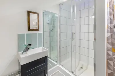 a bathroom with a shower and a sink and a mirror at 1 Bed in St Ives oc-decke in St Ives