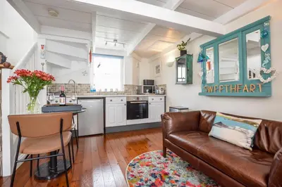 a living room with a couch and a kitchen at 1 Bed in St Ives oc-dgy028 in St Ives