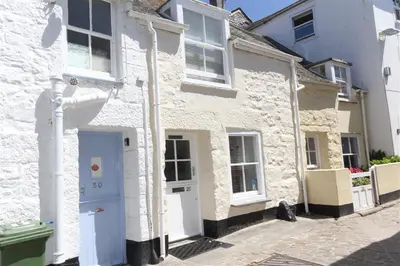 a white house with a blue door on a street at 1 Bed in St Ives oc-dgy028 in St Ives