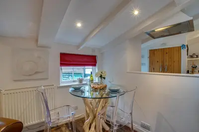 a dining room with a glass table and chairs at 1 Bed in St. Ives oc-drift4 in St Ives