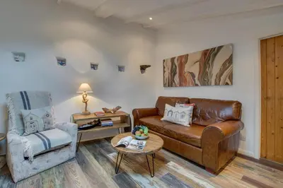 a living room with a leather couch and a chair at 1 Bed in St. Ives oc-drift4 in St Ives