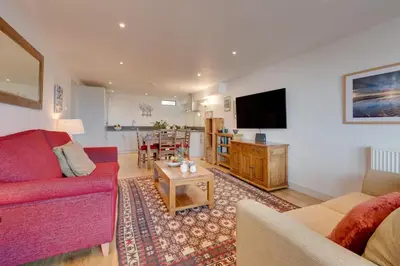 a living room with a red couch and a table at 2 Bed in St Ives oc-f1meor in St Ives