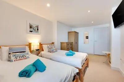 a bedroom with two beds and a flat screen tv at 2 Bed in St Ives oc-f1meor in St Ives
