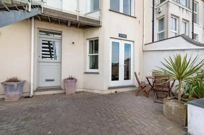 a patio with a table and chairs in front of a building at 2 Bed in St Ives oc-f1meor in St Ives