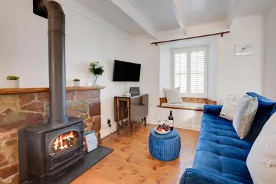 a living room with a blue couch and a fireplace at 1 Bed in St. Ives oc-farr in St Ives