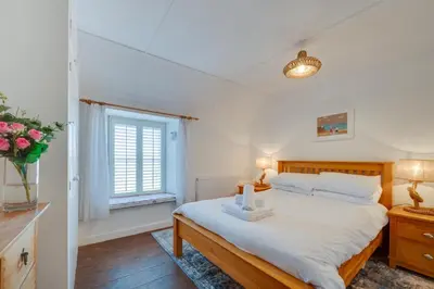 a bedroom with a large bed and a window at 1 Bed in St. Ives oc-farr in St Ives