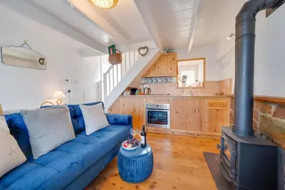 a living room with a blue couch and a wood stove at 1 Bed in St. Ives oc-farr in St Ives