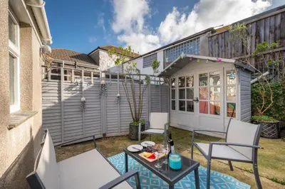a small patio with two chairs and a table at 1 Bed in St. Ives oc-farr in St Ives