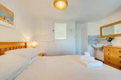 a bedroom with a large white bed and a sink at 1 Bed in St. Ives oc-farr in St Ives