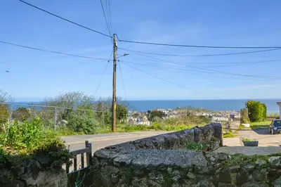 a view of the ocean from a stone wall at 1 Bed in St. Ives oc-farr in St Ives