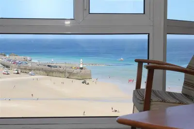 a view from a window of a beach and the ocean at 2 Bed in St Ives oc-fern41 in St Ives