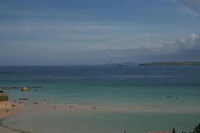 a group of people on a beach in the water at 2 Bed in St Ives oc-fern41 in St Ives