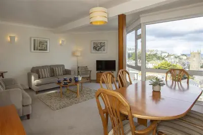 a living room with a dining room table and a couch at 2 Bed in St Ives oc-fern41 in St Ives