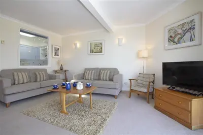 a living room with a couch and a tv and a table at 2 Bed in St Ives oc-fern41 in St Ives