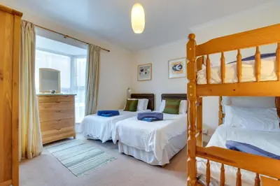 a bedroom with two beds and a bunk bed at 2 Bed in St Ives oc-fern42 in St Ives