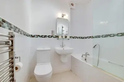 a white bathroom with a toilet and a sink at 2 Bed in St Ives oc-fern42 in St Ives