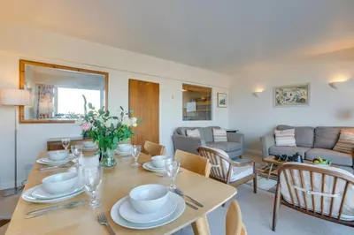 a dining room and living room with a table and chairs at 2 Bed in St Ives oc-fern42 in St Ives