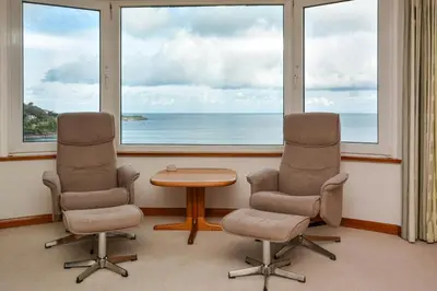 two chairs and a table in a room with windows at 2 Bed in St Ives oc-gmn19 in Carbis Bay