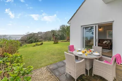 a patio with a table and chairs on a lawn at 2 Bed in St Ives oc-godct7 in Carbis Bay