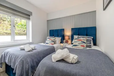 two beds with towels on them in a bedroom at 2 Bed in St Ives oc-godct7 in Carbis Bay