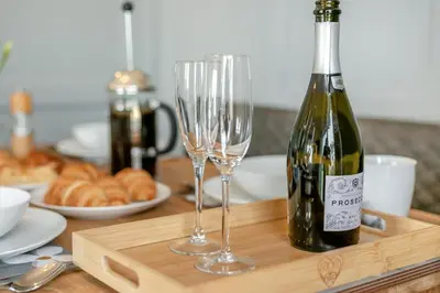a bottle of wine and two glasses on a table at 2 Bed in St Ives oc-godct7 in Carbis Bay
