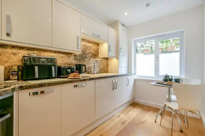 a kitchen with white cabinets and a window at 2 Bed in St Ives oc-godct7 in Carbis Bay