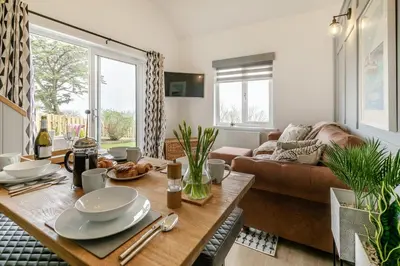 a living room with a table and a couch at 2 Bed in St Ives oc-godct7 in Carbis Bay