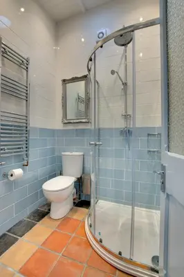 a bathroom with a toilet and a glass shower at Hideaway Tremayne in St Ives