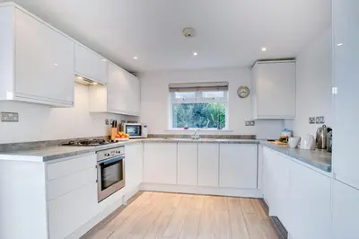a white kitchen with white cabinets and a window at 2 Bed in St Ives oc-holm in Carbis Bay