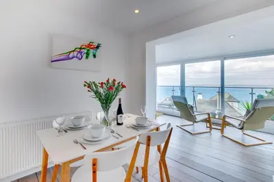 a white dining room with a table and chairs at 2 Bed in St Ives oc-holm in Carbis Bay