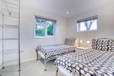 a bedroom with two beds and a glass shower at 2 Bed in St Ives oc-holm in Carbis Bay