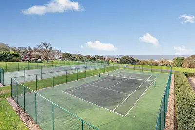 a tennis court with two tennis courts at 3 Bed in St. Ives oc-l26941 in Carbis Bay