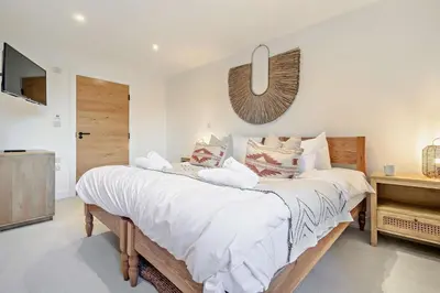 a bedroom with a bed with white sheets and a mirror at 3 Bed in St. Ives oc-l26941 in Carbis Bay