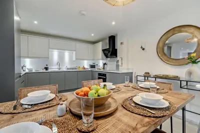 a kitchen with a wooden table with a bowl of fruit on it at 3 Bed in St. Ives oc-l26941 in Carbis Bay