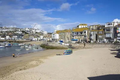 a beach with boats in the water and buildings at 1 Bed in St Ives oc-lhse in St Ives