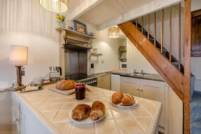 a kitchen with two plates of loaves of bread on a counter at 1 Bed in St Ives oc-lhse in St Ives