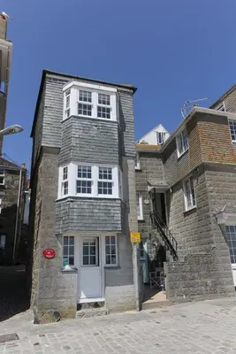 a brick house with a white door on a street at 1 Bed in St Ives oc-lhse in St Ives