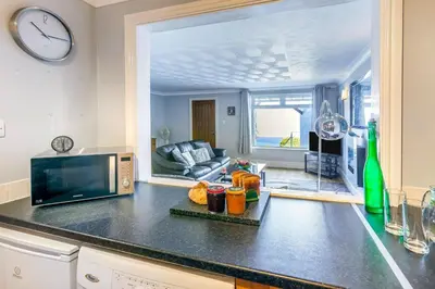 a kitchen with a counter top with a clock on the wall at 2 Bed in St Ives oc-lookcv in St Ives