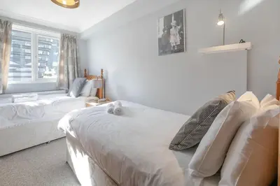 a white bedroom with a bed and a window at 2 Bed in St Ives oc-lookcv in St Ives